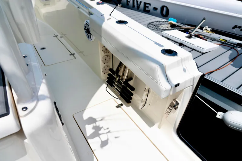 Slide: The Image of 2024 Cobia 350 boat interior with fishing rod holders and deck equipment. - 14