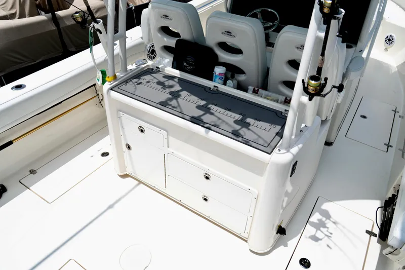 Slide: The Image of 2024 Cobia 350 boat interior with fishing rod holders and storage compartments. - 8