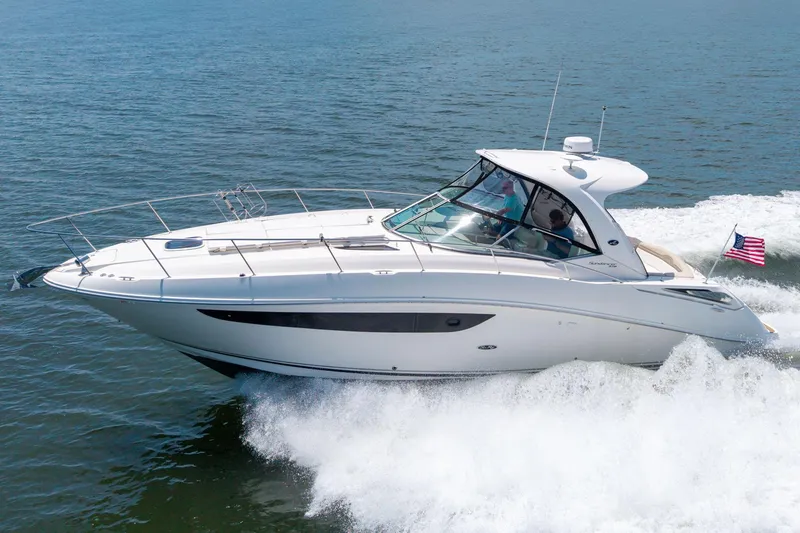 The Image of 2013 Sea Ray 370 Sundancer cruising on open water with American flag. - 1