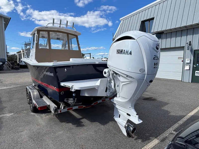Slide: The Image of 2026 NorthCoast 235 HT boat with Yamaha outboard motor on a trailer, parked outdoors. - 2