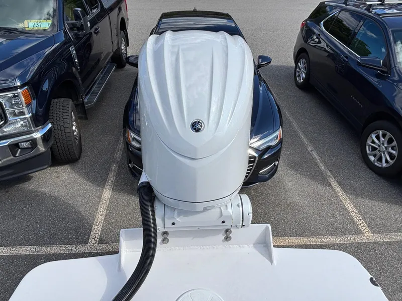 Slide: The Image of NorthCoast 235 HT 2026 boat engine in parking lot, surrounded by vehicles. - 6