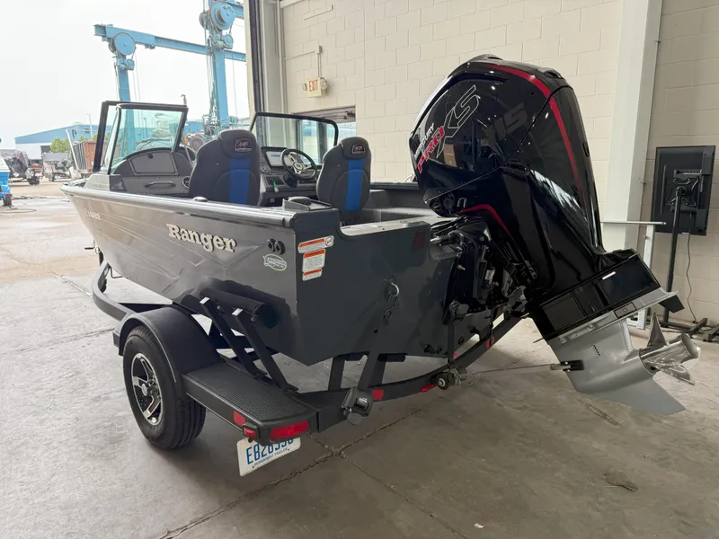 Slide: The Image of 2023 Ranger VS1682 WT boat with powerful outboard motor in a garage setting. - 3