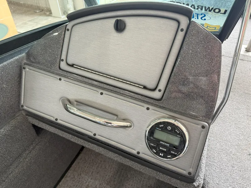 Slide: The Image of 2023 Ranger VS1682 WT boat dashboard with storage compartment and audio controls. - 6