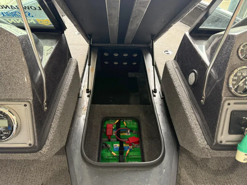 Slide: The Image of 2023 Ranger VS1682 WT boat interior showing battery compartment and dashboard controls. - 8