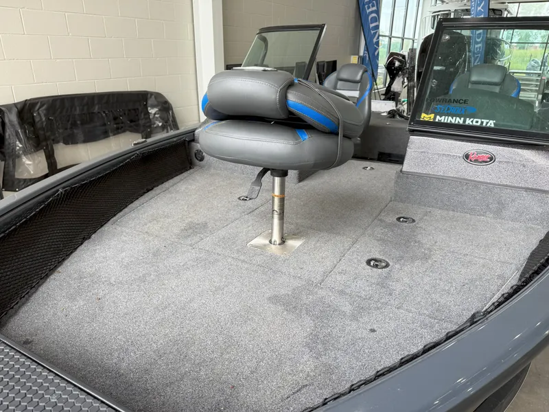 Slide: The Image of 2023 Ranger VS1682 WT boat interior with gray seating and carpeted deck. - 9