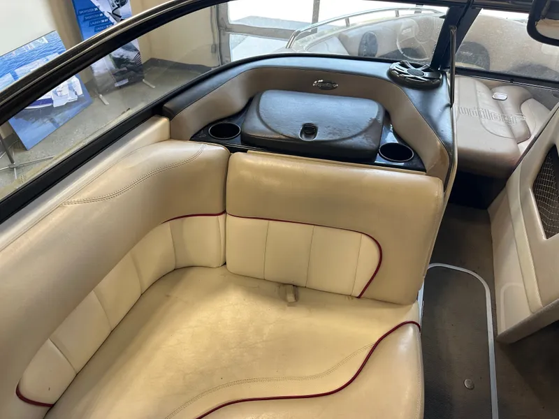 Slide: The Image of 2004 Malibu Wakesetter LSV interior with beige seating and cup holders. - 10