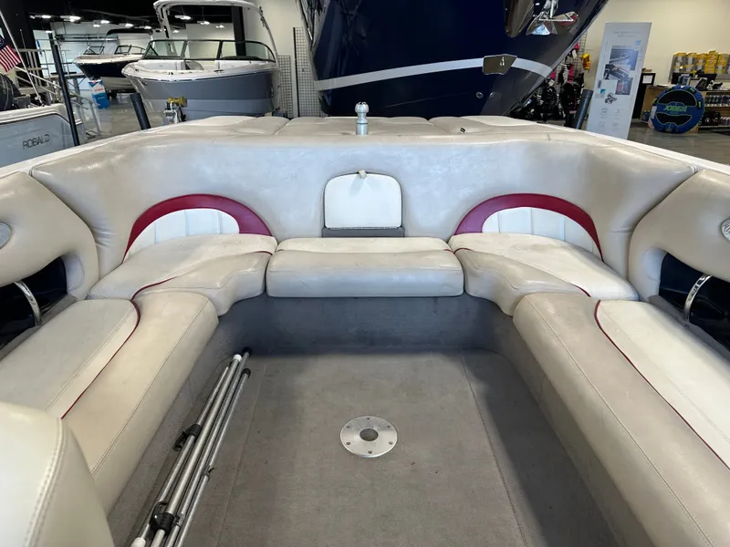Slide: The Image of 2004 Malibu Wakesetter LSV interior with white and red seating in a showroom. - 12
