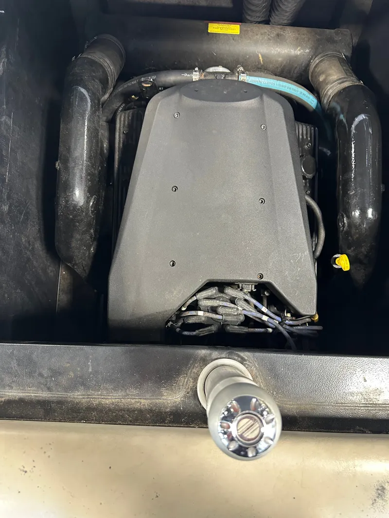Slide: The Image of Engine compartment of a 2004 Malibu Wakesetter LSV boat, showing engine and components. - 13