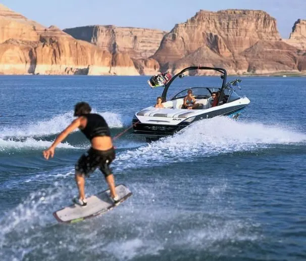 Slide: The Image of 2004 Malibu Wakesetter LSV towing a wakeboarder on a scenic lake. - 14