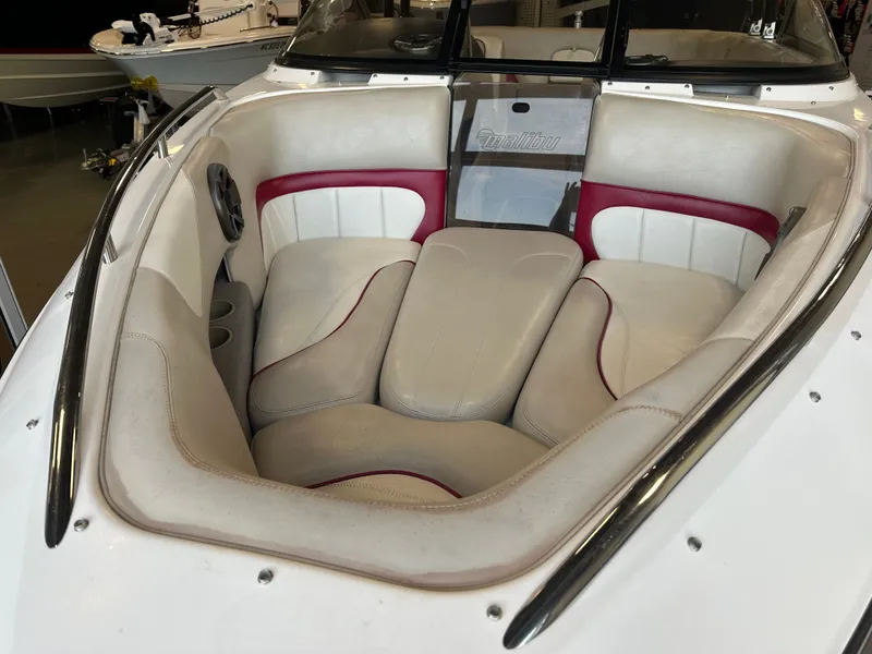 Slide: The Image of 2004 Malibu Wakesetter LSV boat interior with white and red seating. - 5
