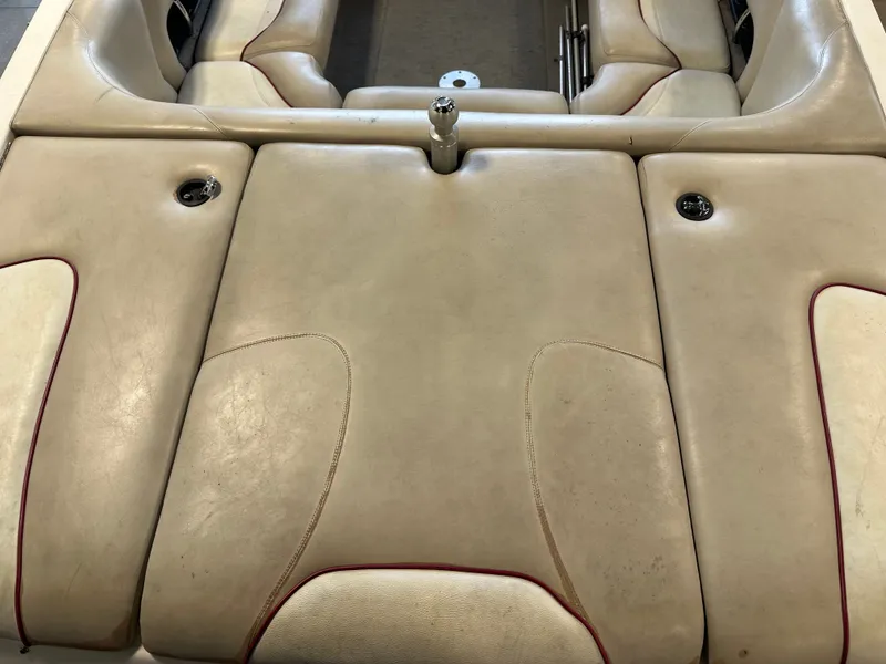 Slide: The Image of 2004 Malibu Wakesetter LSV boat interior with beige upholstery and red accents. - 6