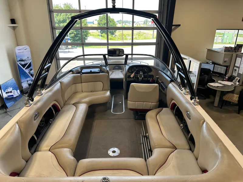 Slide: The Image of 2004 Malibu Wakesetter LSV interior with beige seating and black tower in showroom. - 7