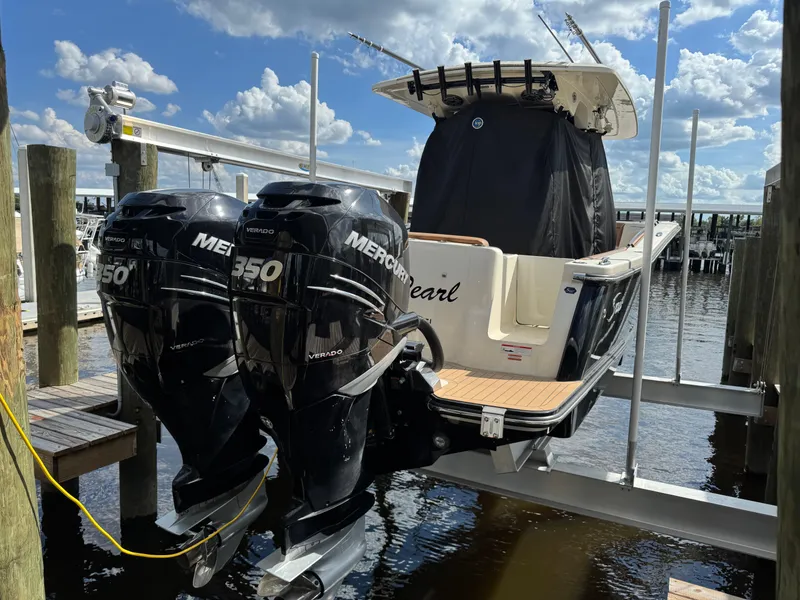 Slide: The Image of 2021 Scout 330 LXF boat with twin Mercury 350 Verado engines on a lift. - 32