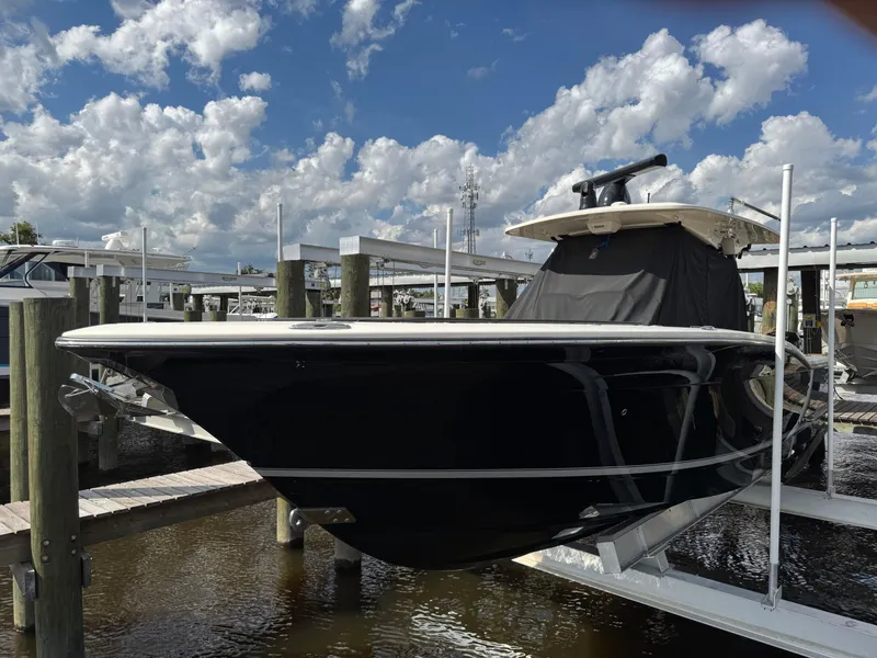 Slide: The Image of 2021 Scout 330 LXF boat docked under a cloudy sky. - 34