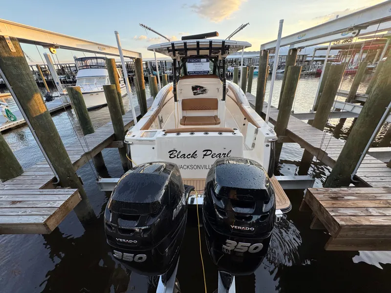 Slide: The Image of 2021 Scout 330 LXF boat docked with twin Verado 350 engines. - 38