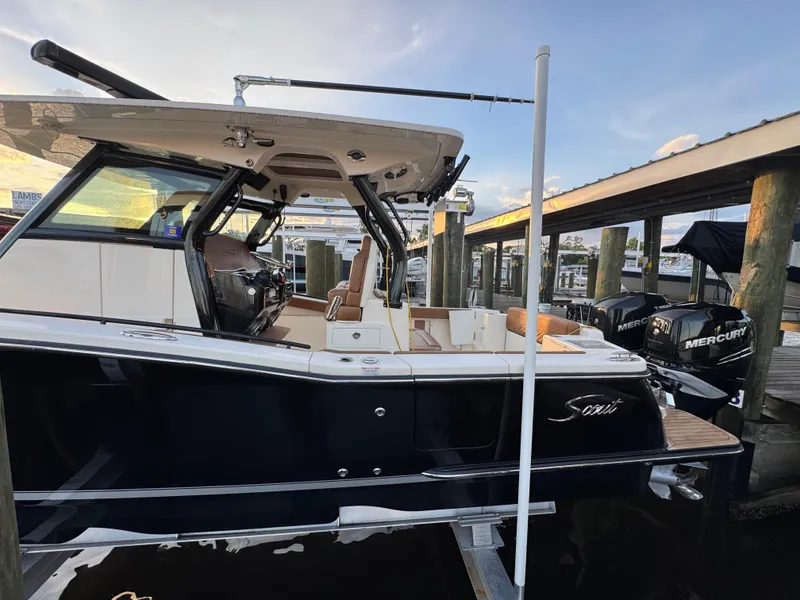 Slide: The Image of 2021 Scout 330 LXF boat docked with Mercury engines, side view. - 39