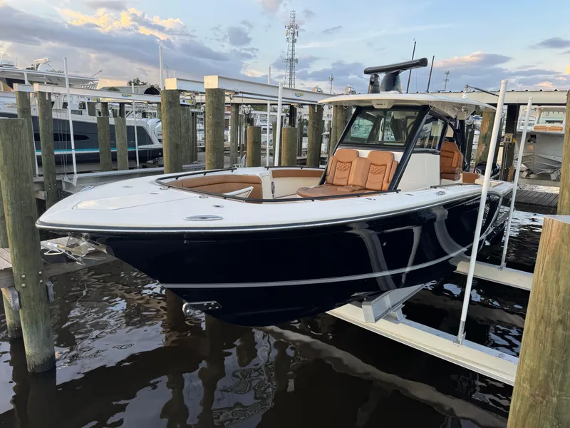 Slide: The Image of 2021 Scout 330 LXF boat docked, featuring sleek design and luxurious seating. - 42