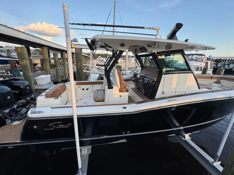 Slide: The Image of 2021 Scout 330 LXF boat docked, featuring sleek design and modern amenities. - 45