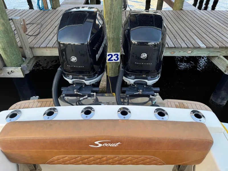 Slide: The Image of 2021 Scout 330 LXF boat with dual Mercury outboard engines at dock. - 49