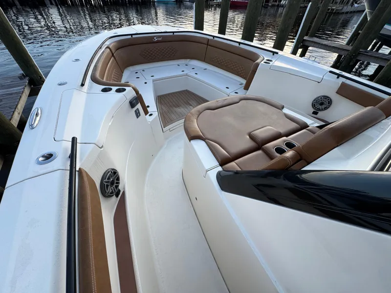 Slide: The Image of 2021 Scout 330 LXF boat interior with luxurious seating and cup holders. - 51