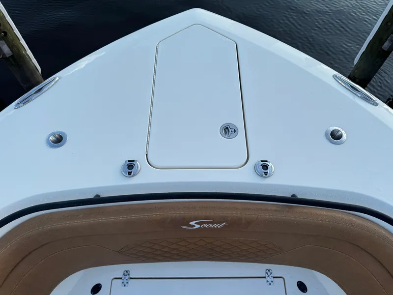 Slide: The Image of Bow of 2021 Scout 330 LXF boat with storage hatch and logo. - 55