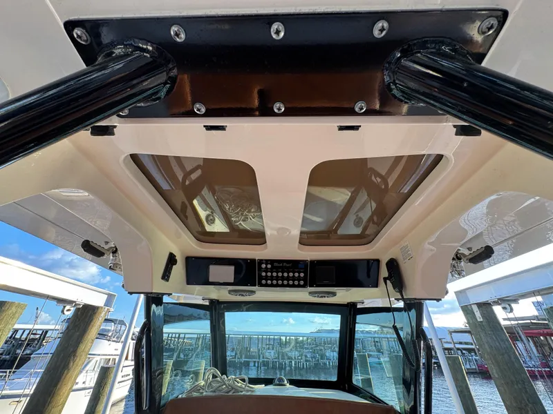 Slide: The Image of 2021 Scout 330 LXF boat interior with sunroof and control panel. - 64