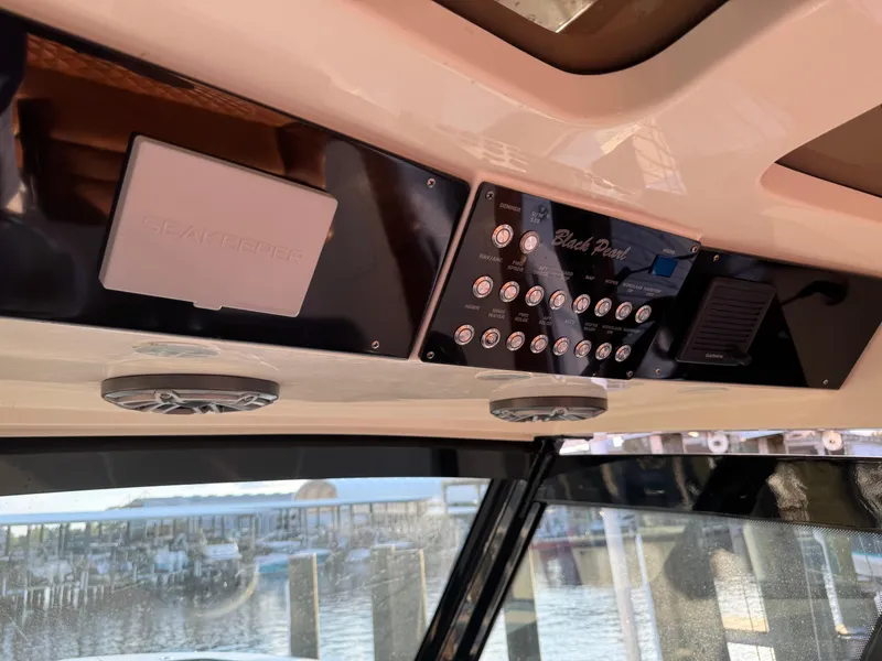 Slide: The Image of 2021 Scout 330 LXF boat dashboard with control panel and Seakeeper system. - 65