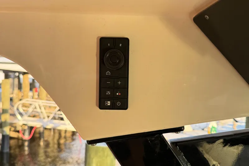Slide: The Image of Control panel on a 2021 Scout 330 LXF boat, featuring various buttons and a joystick. - 66