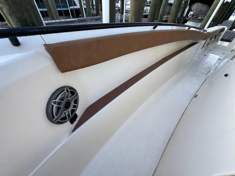 Slide: The Image of 2021 Scout 330 LXF boat interior with speaker and brown trim detail. - 70