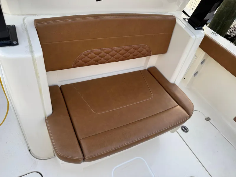 Slide: The Image of Brown leather seat on 2021 Scout 330 LXF boat, featuring diamond stitching. - 73