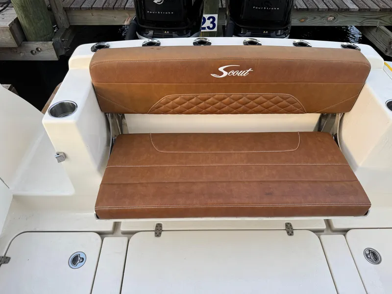 Slide: The Image of 2021 Scout 330 LXF boat with brown leather seating and cup holders. - 74