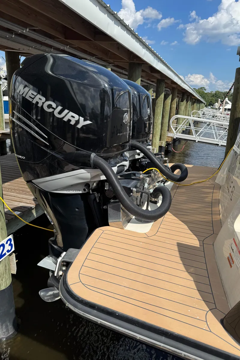Slide: The Image of 2021 Scout 330 LXF boat with Mercury outboard engine at dockside. - 85