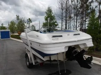 Slide: The Image of 2004 Mariah SK-10 boat on trailer, parked outdoors under cloudy sky. - 5