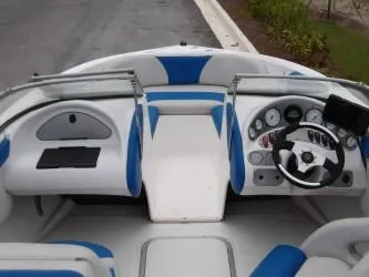 Slide: The Image of 2004 Mariah SK-10 boat interior with blue and white seating and dashboard controls. - 8