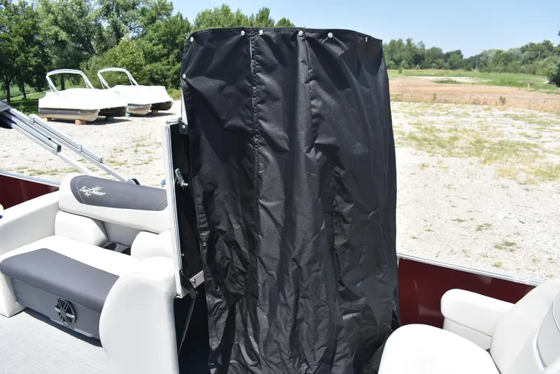 Slide: The Image of 2024 SunChaser Geneva 20 Fish 4 pontoon boat interior with black privacy curtain. - 14