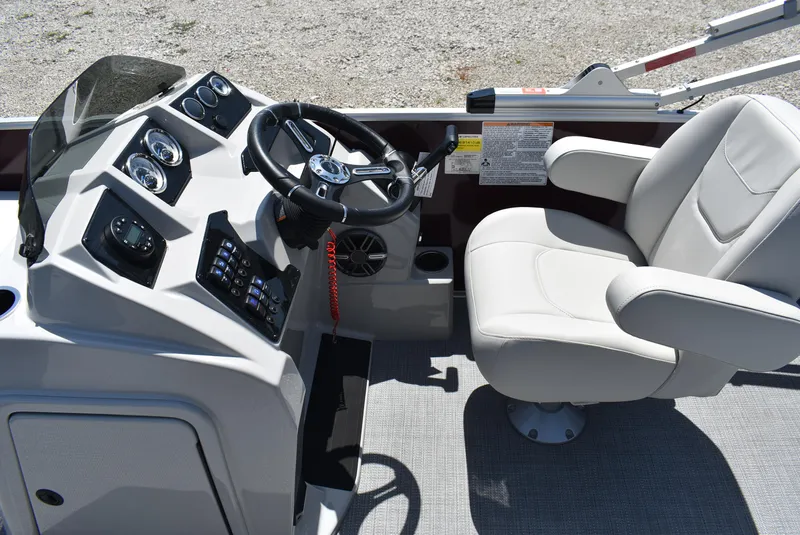 Slide: The Image of 2024 SunChaser Geneva 20 Fish 4 boat cockpit with steering wheel and captain's chair. - 8