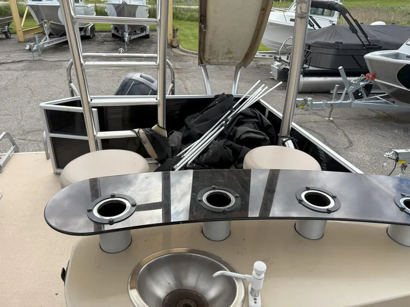 Slide: The Image of 2016 Sweetwater Premium Edition 240 SD boat interior with sink and seating area. - 11