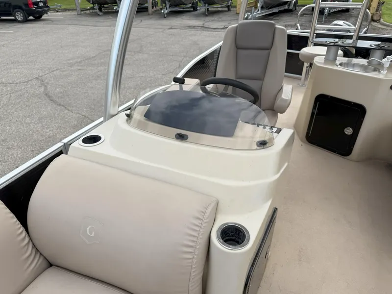 Slide: The Image of 2016 Sweetwater Premium Edition 240 SD boat interior with helm and seating. - 12