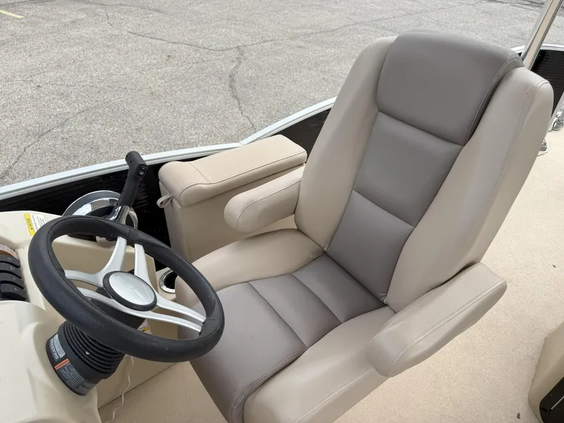 Slide: The Image of Captain's chair and steering wheel of 2016 Sweetwater Premium Edition 240 SD boat. - 13