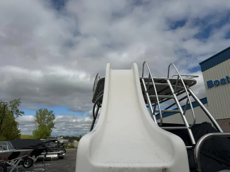 Slide: The Image of 2016 Sweetwater Premium Edition 240 SD boat with slide under cloudy sky. - 15