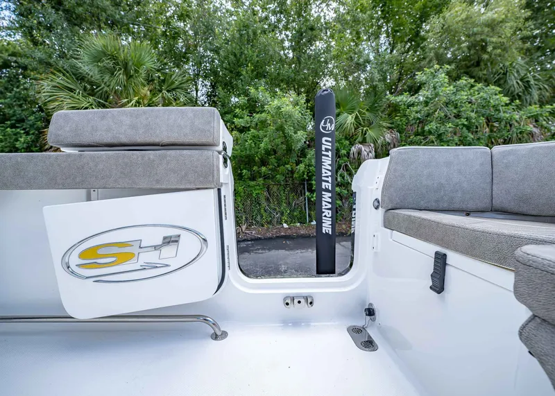 Slide: The Image of 2026 Sea Hunt Ultra 305 SE boat interior with cushioned seating and Ultimate Marine branding. - 11