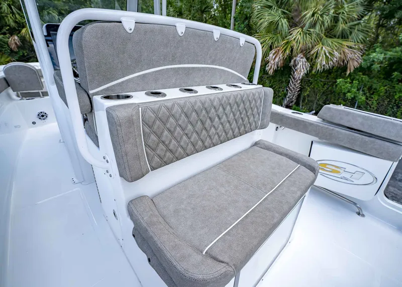 Slide: The Image of 2026 Sea Hunt Ultra 305 SE boat seating with cup holders, featuring elegant gray upholstery. - 14