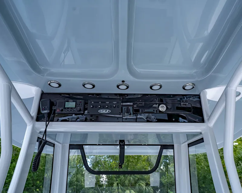 Slide: The Image of 2026 Sea Hunt Ultra 305 SE boat console with electronic controls and overhead lighting. - 18