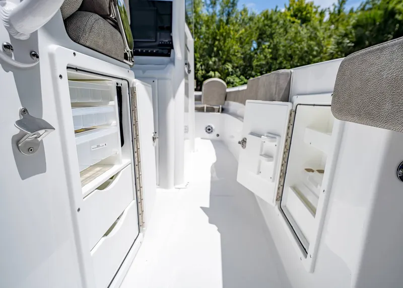Slide: The Image of 2026 Sea Hunt Ultra 305 SE boat interior with open storage compartments. - 29