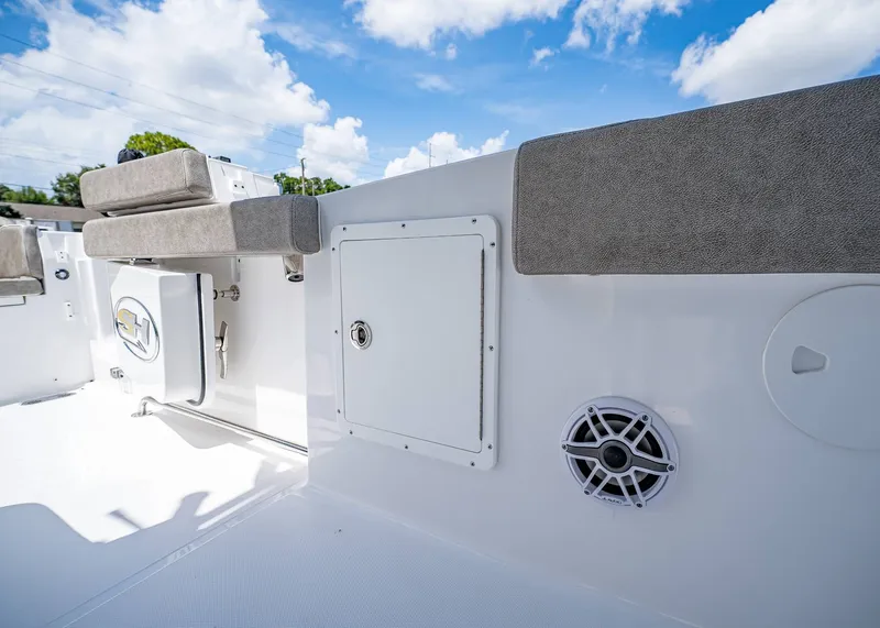 Slide: The Image of 2026 Sea Hunt Ultra 305 SE boat interior with cushioned seating and storage compartments. - 30