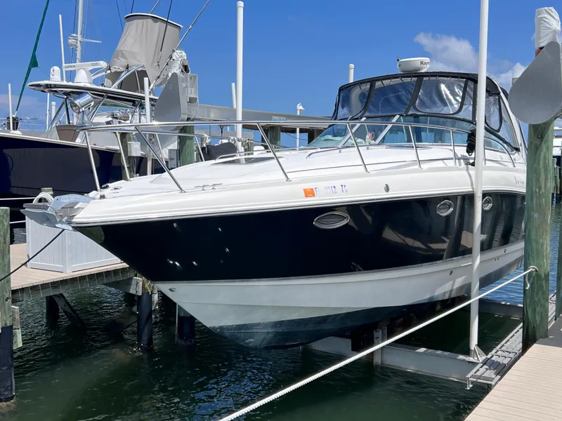 The Image of 2005 Chaparral Signature 350 boat docked at marina under clear blue sky. - 0
