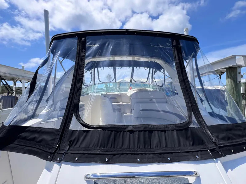 Slide: The Image of 2005 Chaparral Signature 350 boat with clear enclosure, docked under blue sky. - 10