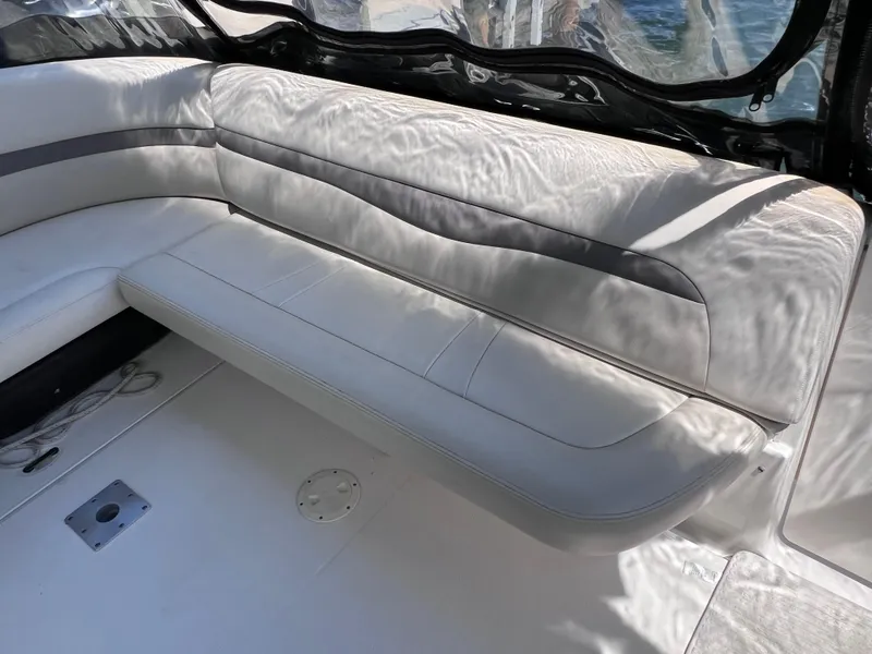 Slide: The Image of 2005 Chaparral Signature 350 boat interior with white leather seating and sunlight reflections. - 19