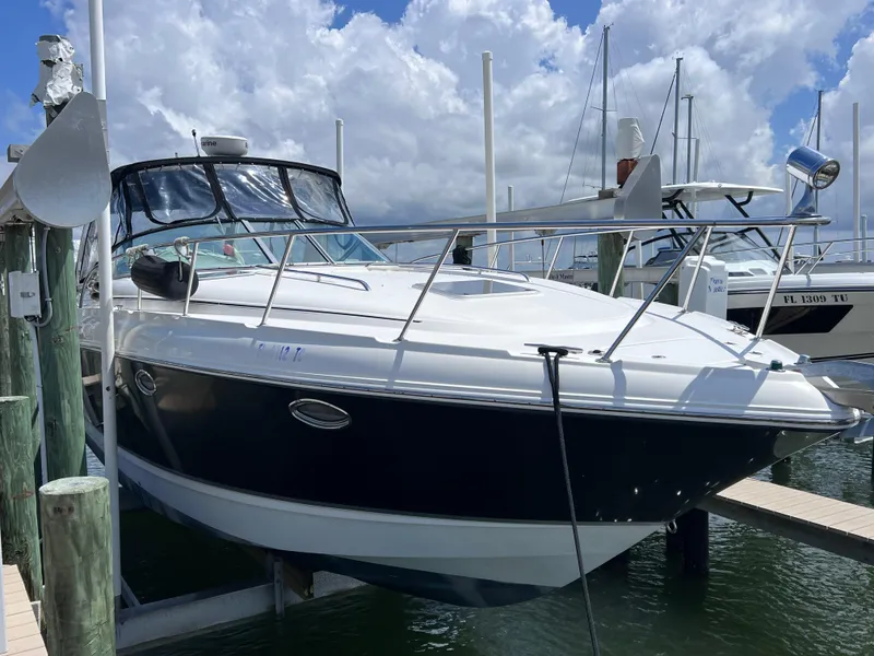 Slide: The Image of 2005 Chaparral Signature 350 boat docked at marina under cloudy sky. - 2