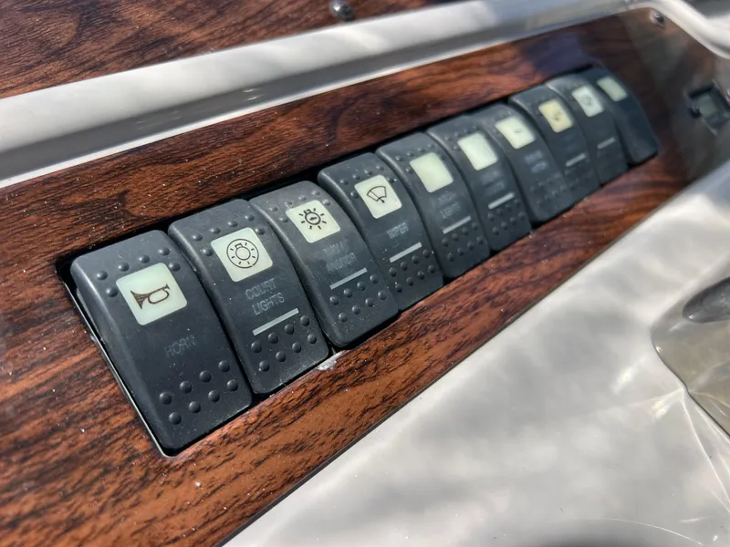 Slide: The Image of Control panel of a 2005 Chaparral Signature 350 boat with labeled switches. - 23